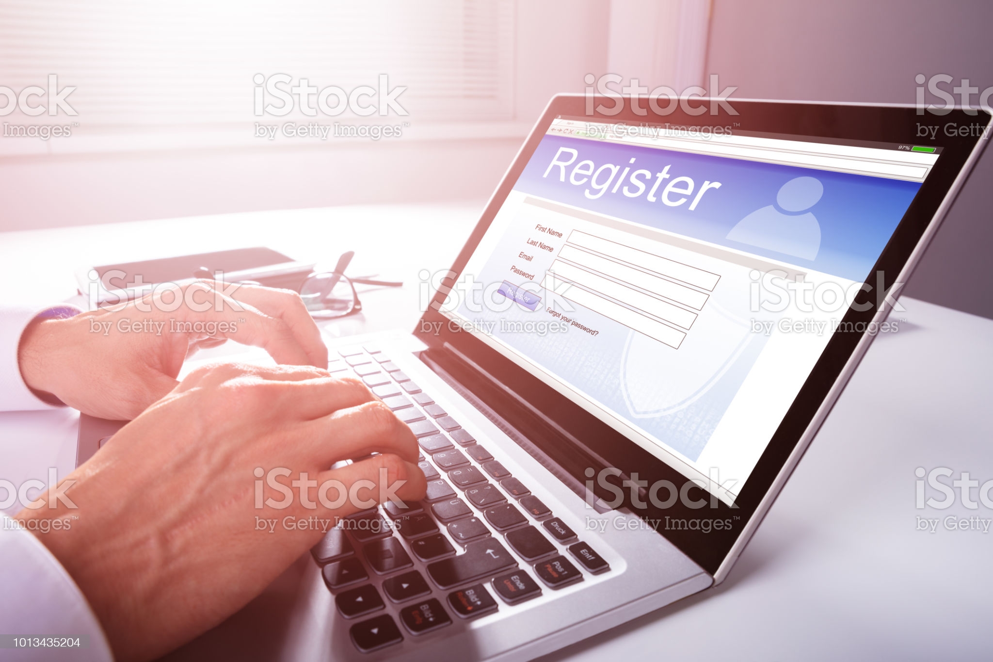 Businessman's Hand Filling Online Registration Form On Laptop Businessman's Hand Filling Online Registration Form On Laptop